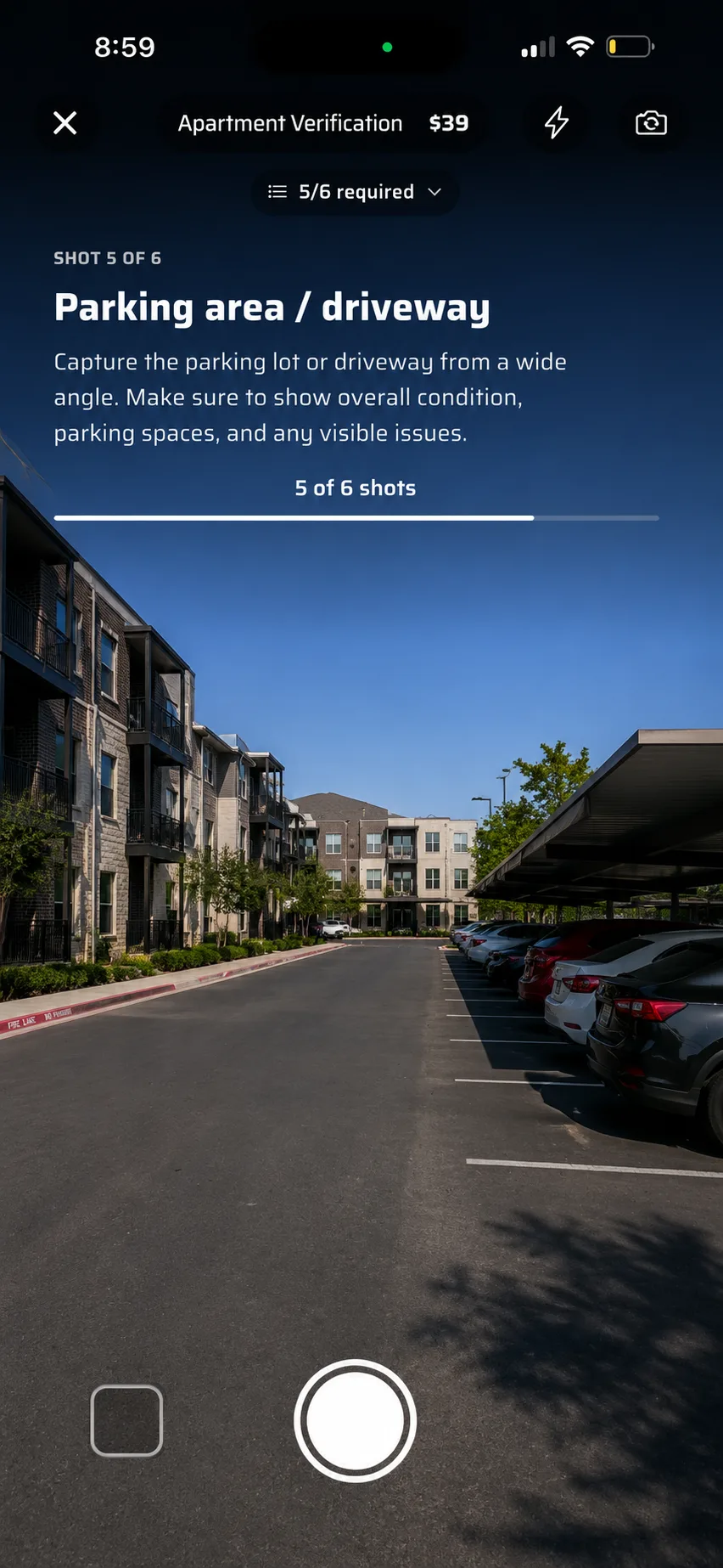 The in-app camera on shot 5 of 6, captioned Parking area and driveway, with the shot brief above the viewfinder.
